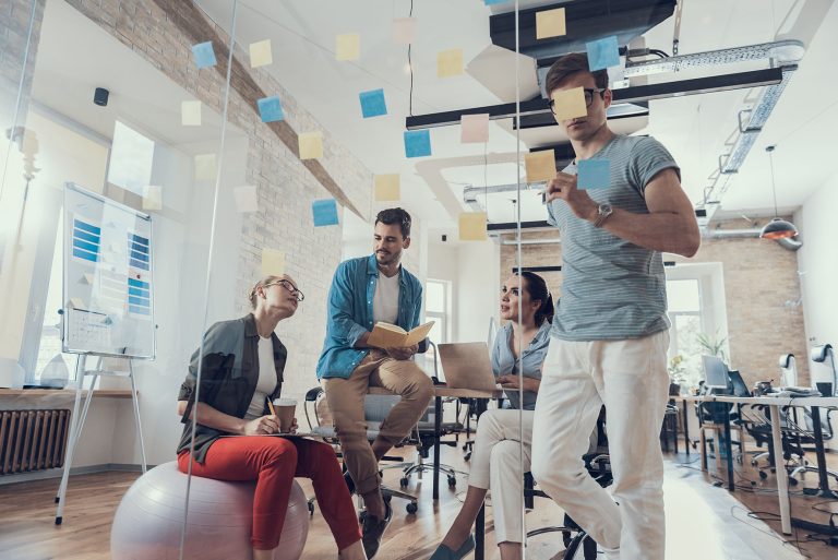 Young partners are having positive workday in meeting room