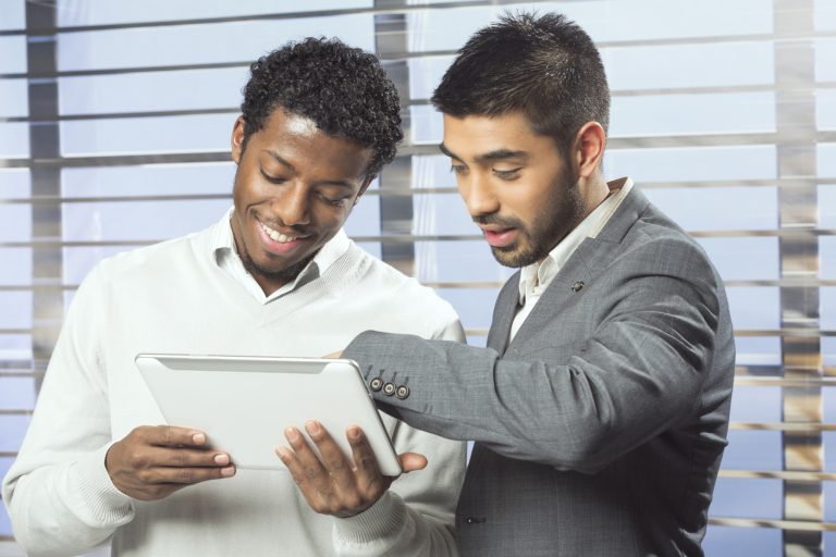 Two businessmen working together with tablet